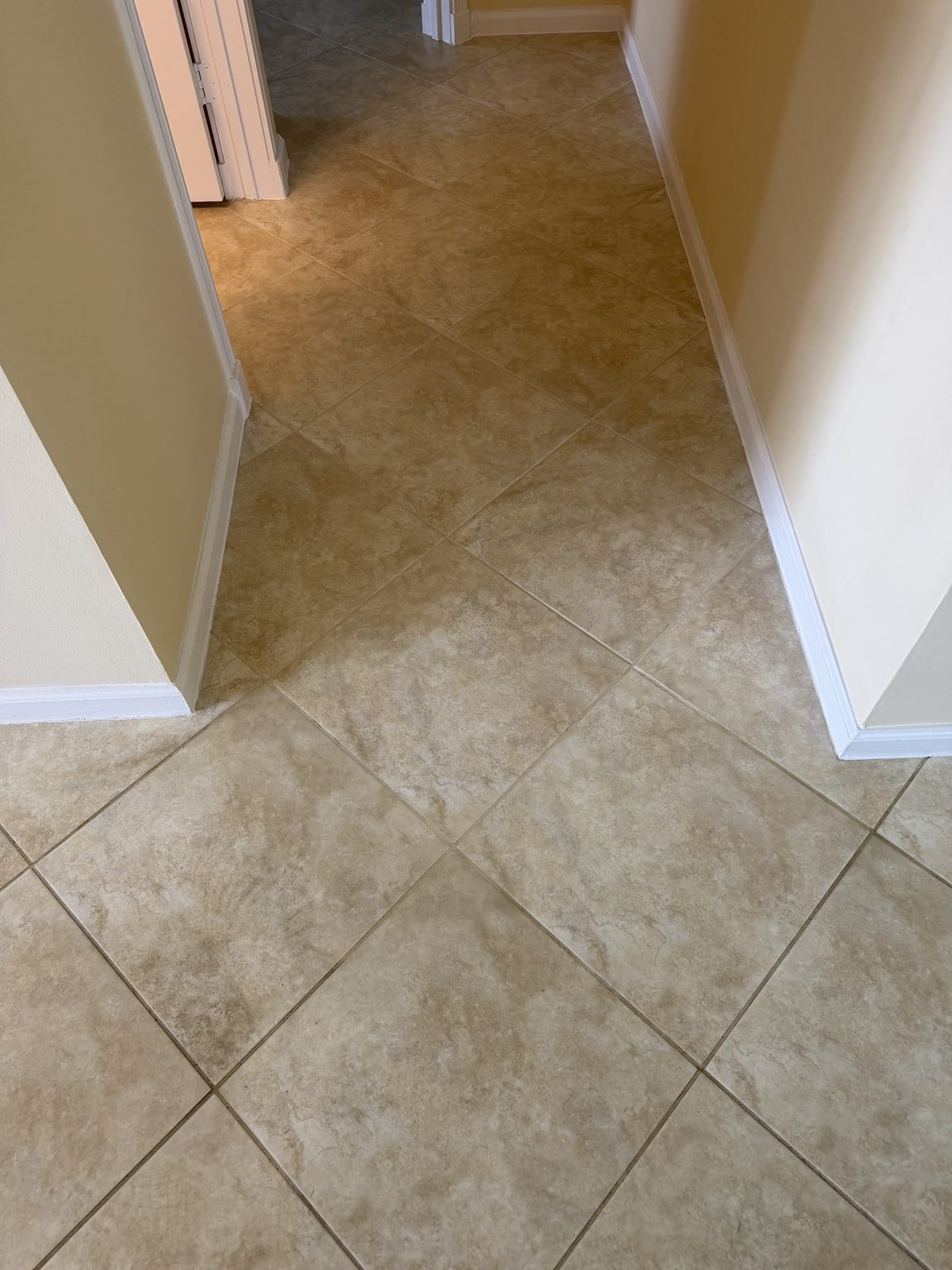 Beige tile and grout lines in the hallway of a Delray Beach home.